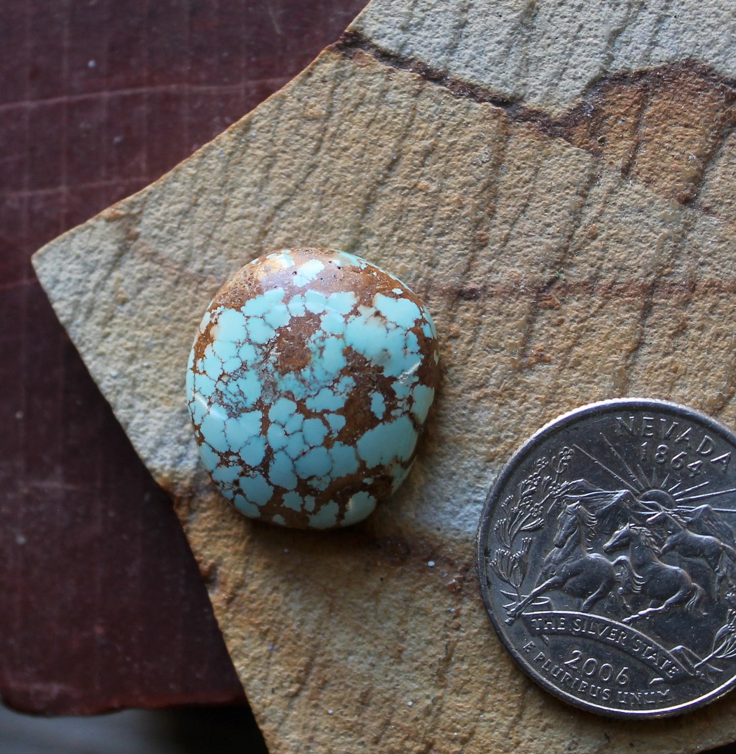 20 carat blue Stone Mountain Turquoise cabochon with red webbing