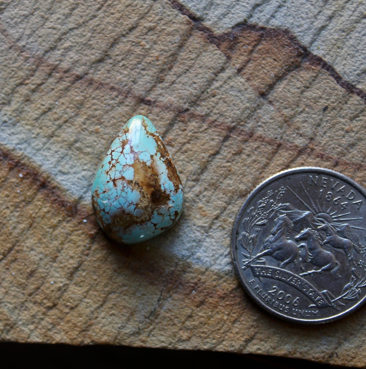 13 carat blue Stone Mountain Turquoise cabochon with red webbing and a high dome