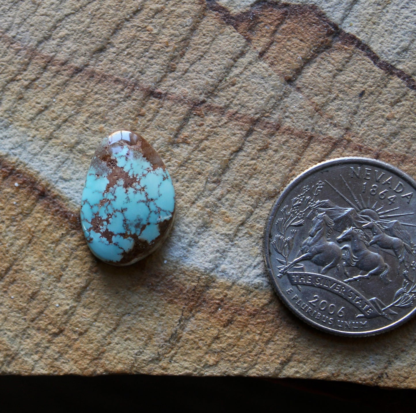 8 carat blue Stone Mountain Turquoise cabochon with red webbing