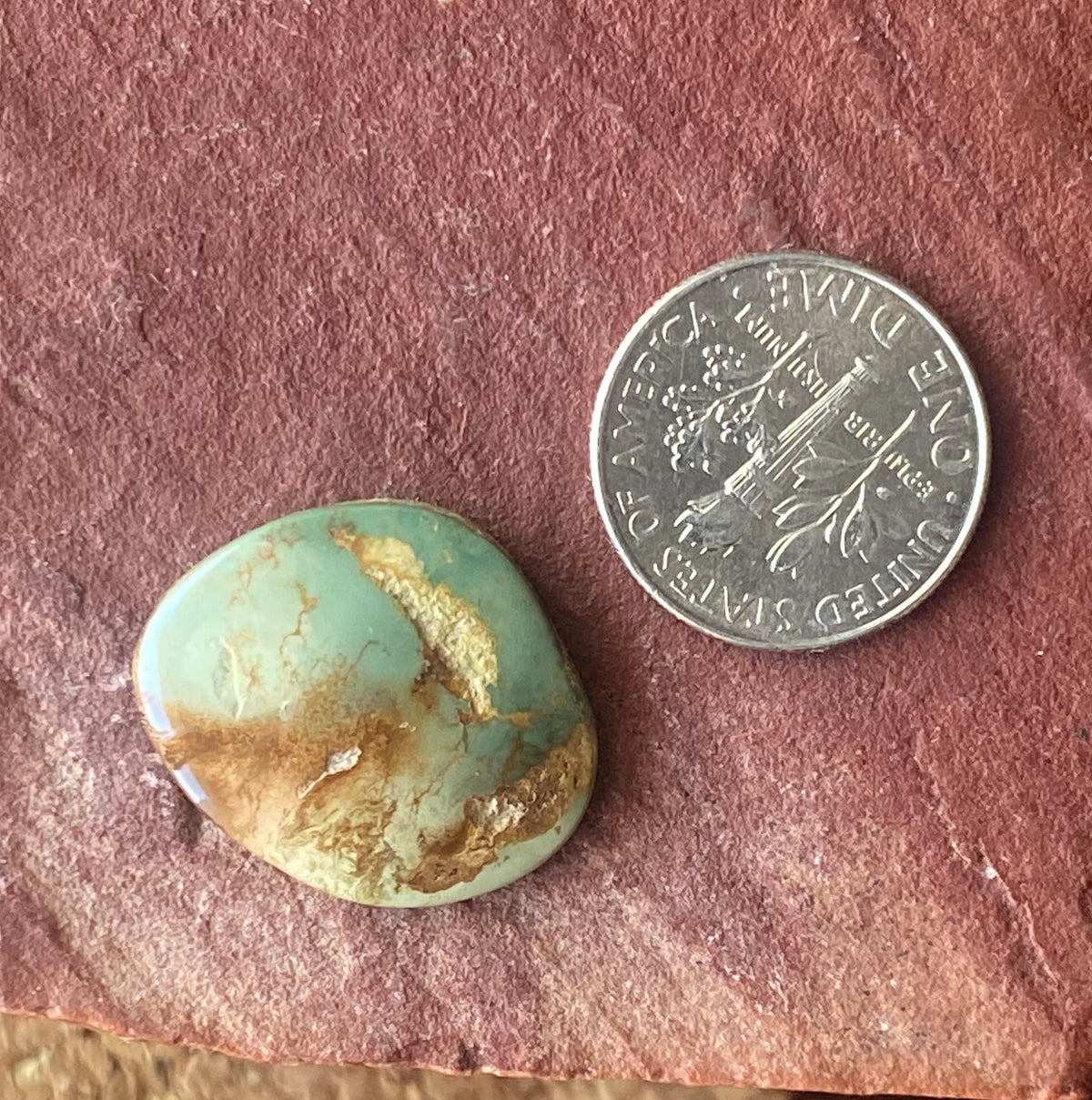 13 carat green Stone Mountain Turquoise cabochon with red inclusions