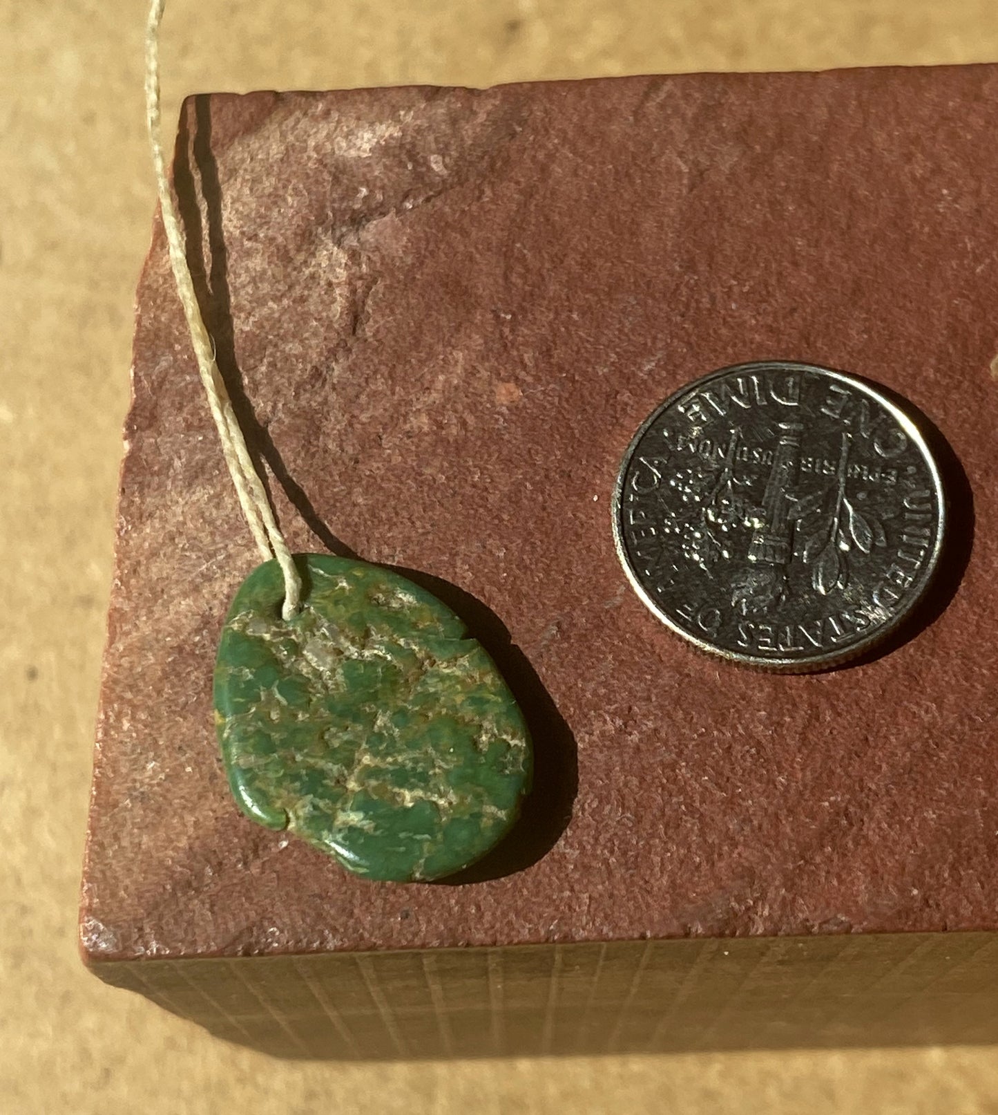 7 carat dark green Stone Mountain Turquoise tab style bead with inclusions