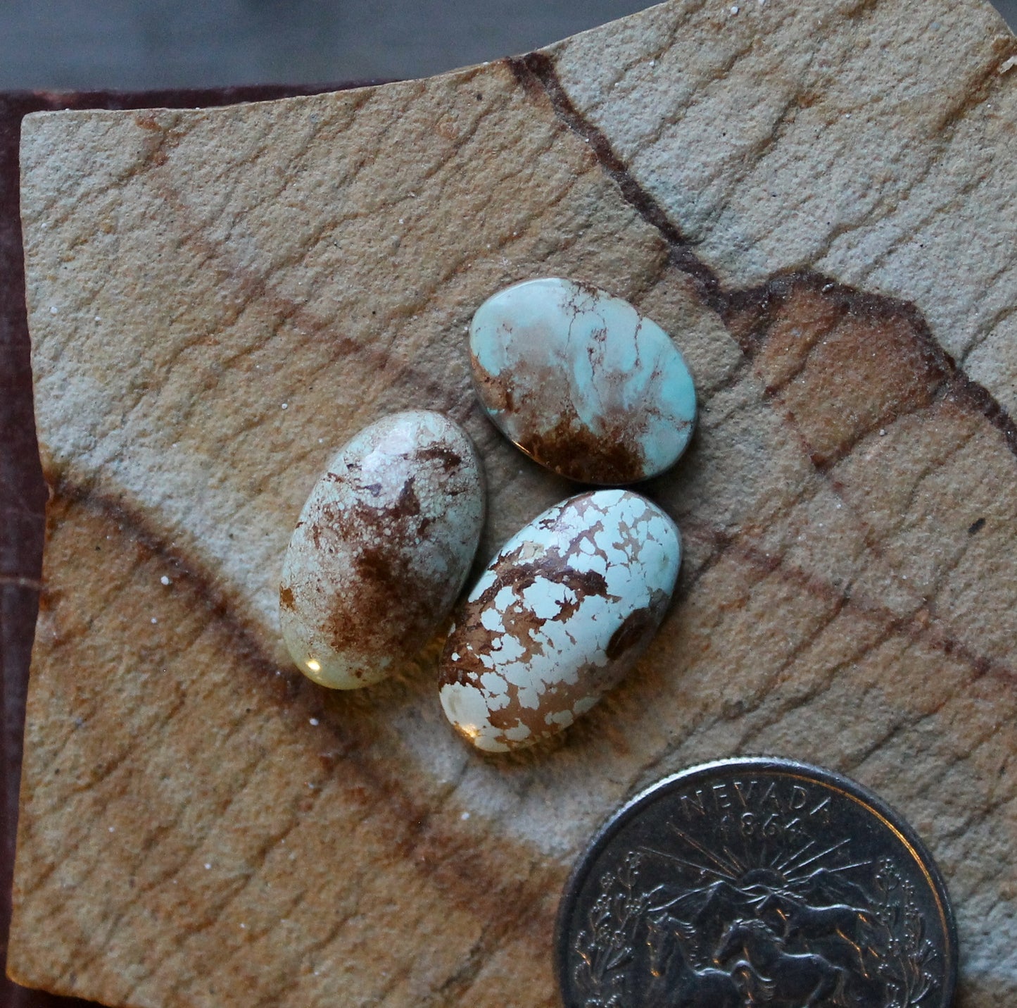 A trio of light blue Stone Mountain Turquoise cabochons with red matrix