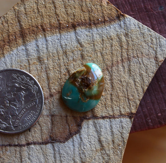 9 carat blue Stone Mountain Turquoise cabochon with red inclusions and a high dome 9 carat blue Stone Mountain Turquoise cabochon with red inclusions and a high dome