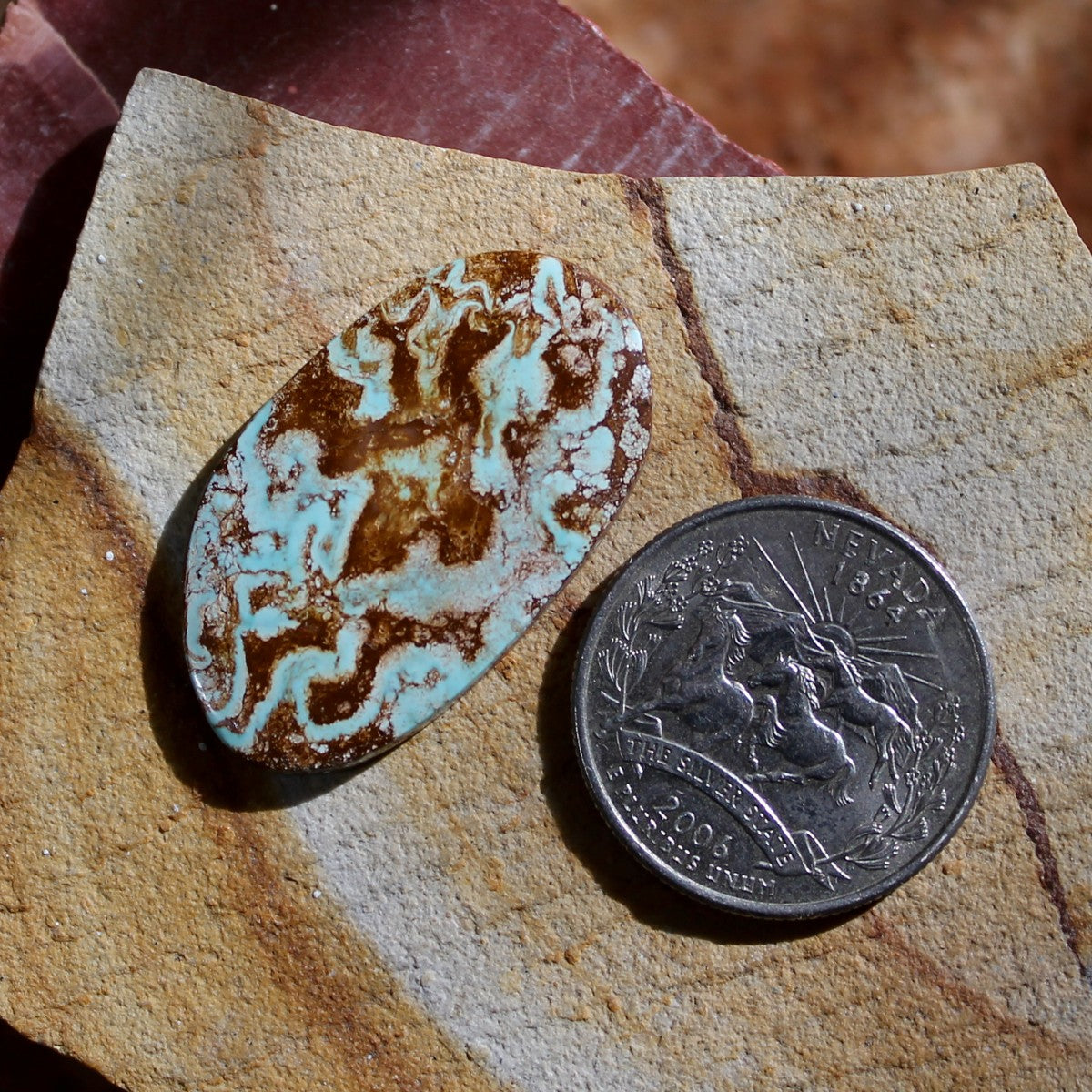 19.9 carats light blue Stone Mountain Turquoise cabochon with red matrix