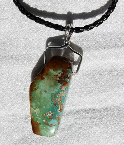 Polychrome Reversible Stone Mountain Turquoise "Character Bead" pendant Here is a gorgeous reversible character bead pendant using a polychrome Stone Mountain Turquoise bead designed by the Nevada Cassidys
