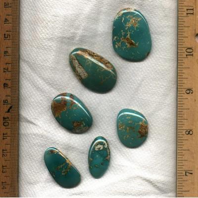 A stunning teal Stone Mountain Turquoise cabochon suite designed by the Nevada Cassidys