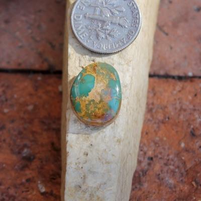 Teal-green shades contrasted by red-brown matrix on this natural Nevada turquoise cabochon