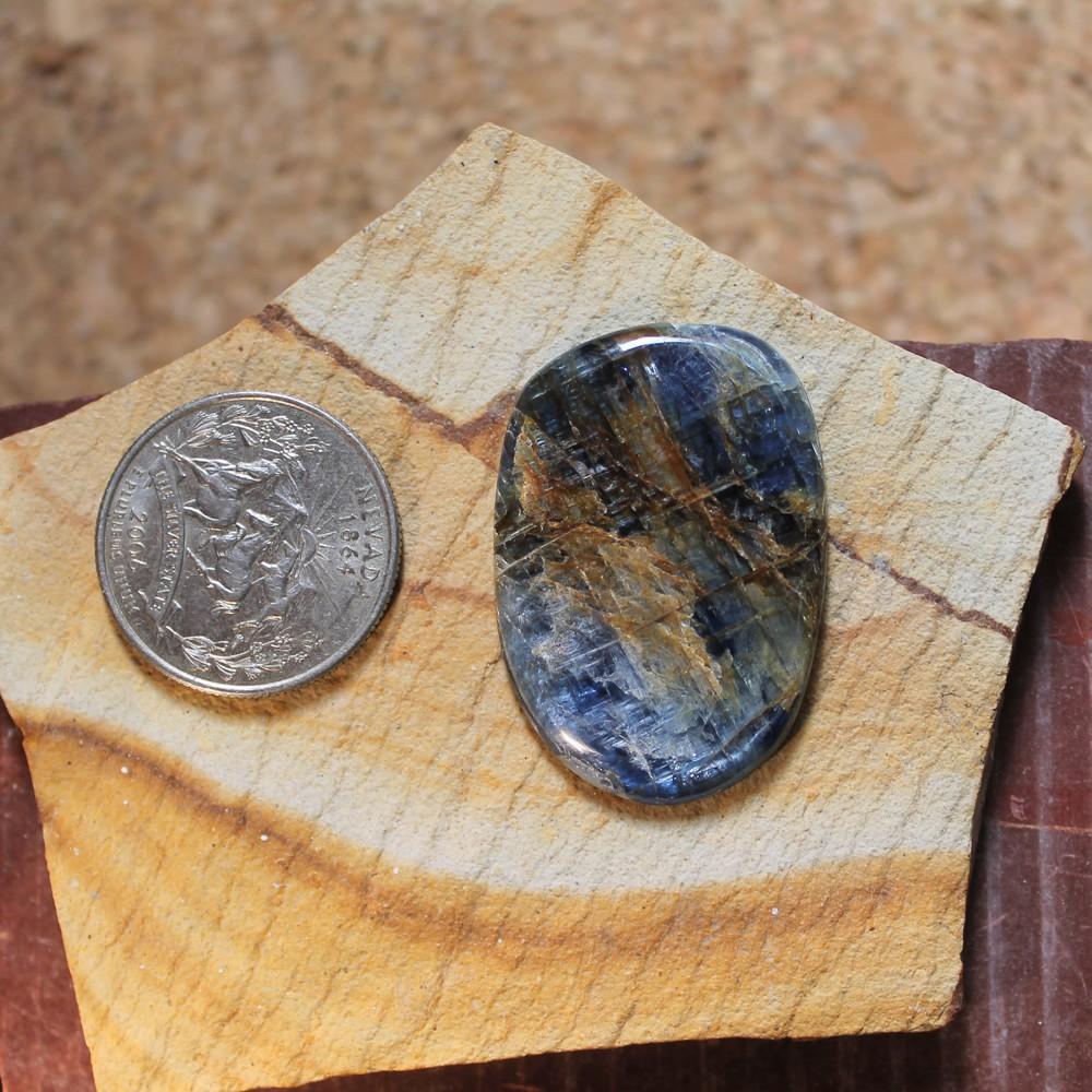 47 carat blue kyanite cabochon with orange flash - Nevada Cassidys