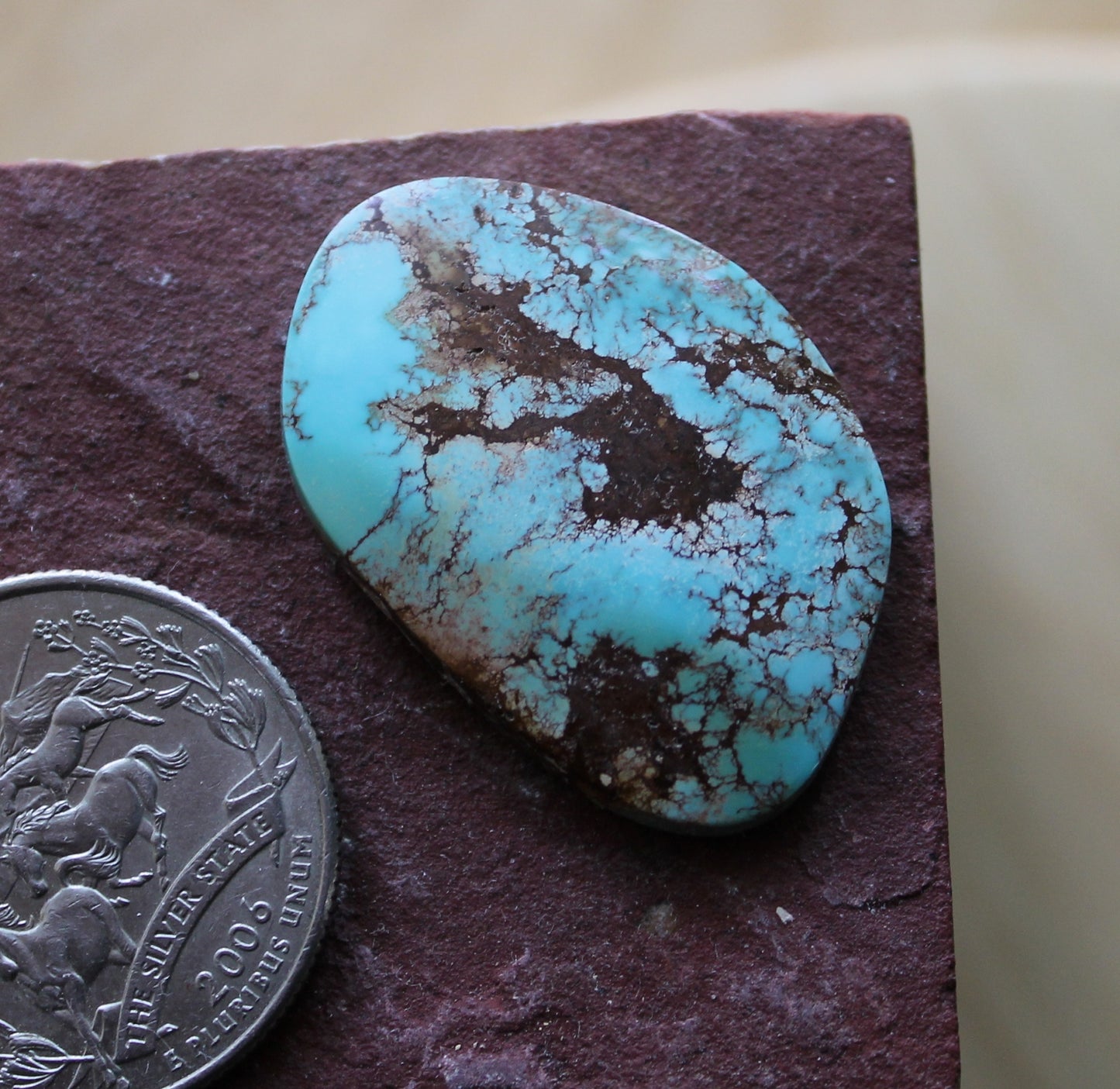 22 carat blue Stone Mountain Turquoise cabochon with red matrix