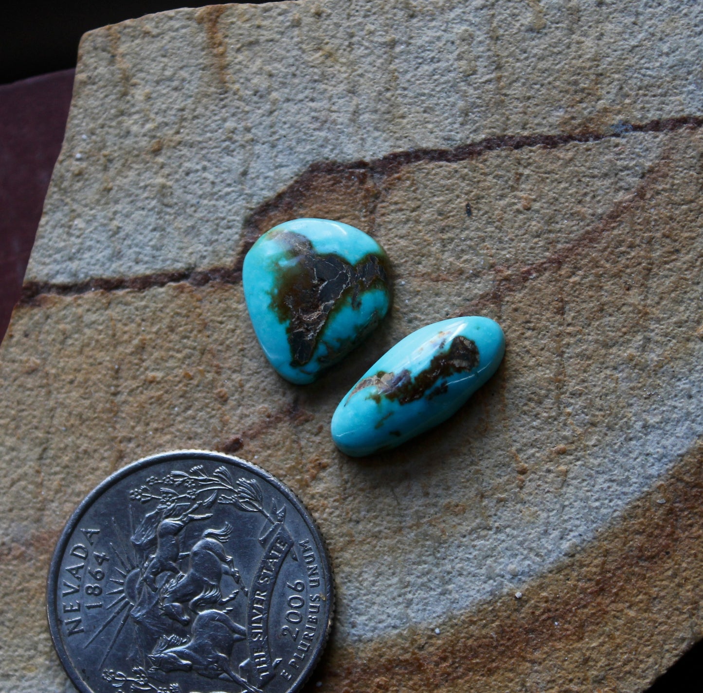 Two natural Blue June turquoise cabochons with red matrix