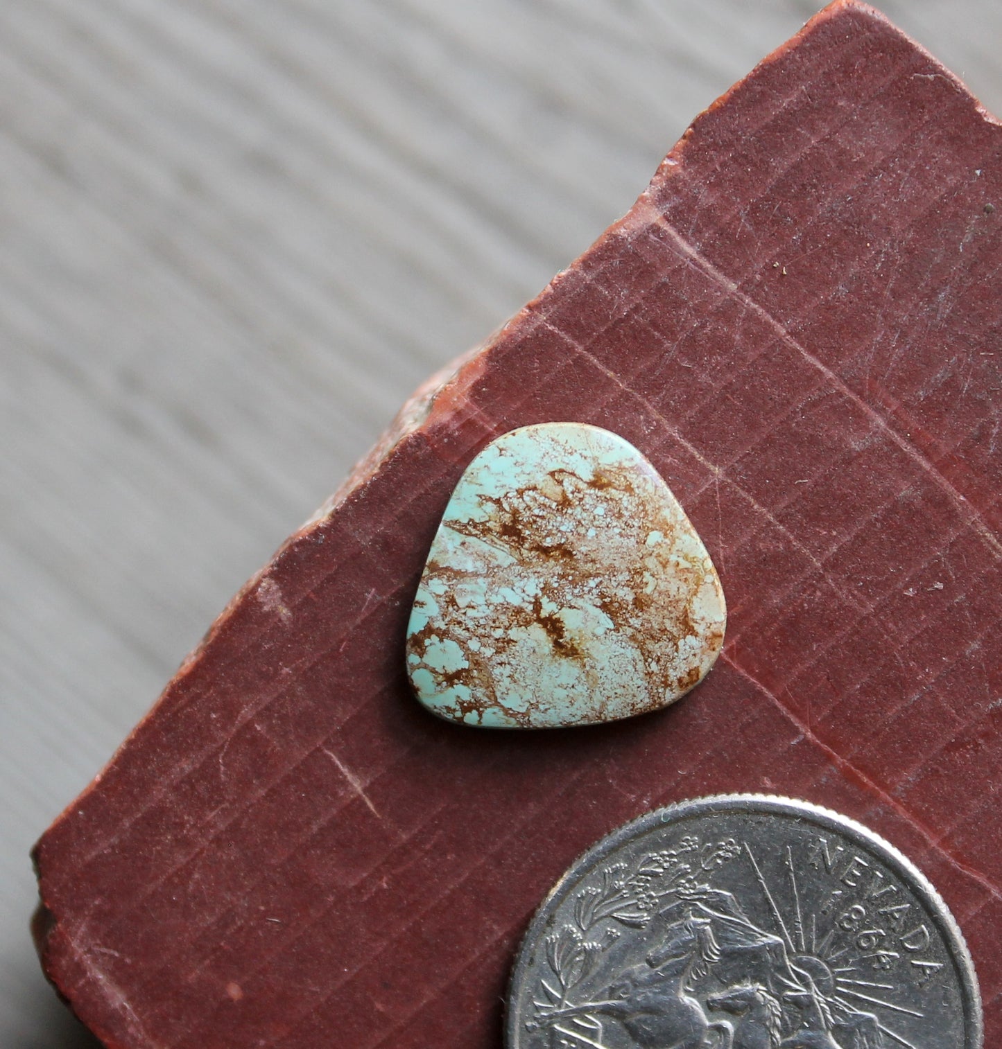 5 carat light blue Stone Mountain Turquoise cabochon with red inclusions