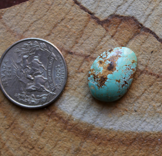 12 carat blue Stone Mountain Turquoise cabochon with red webbing and a high dome