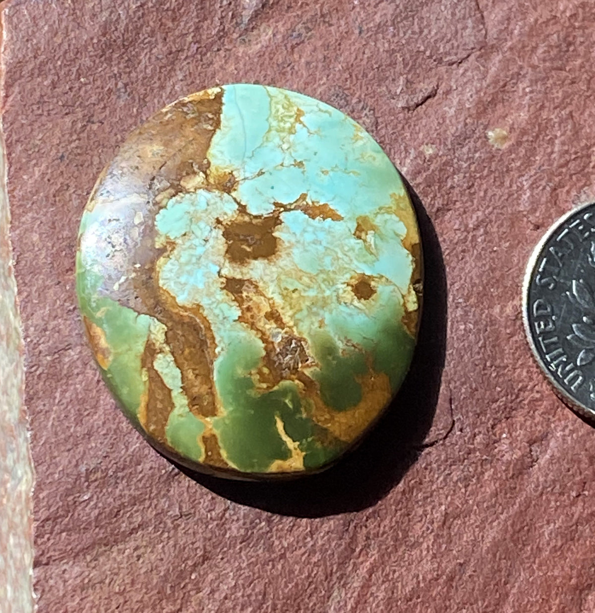 25 carat color change Stone Mountain Turquoise cabochon oval with red matrix
