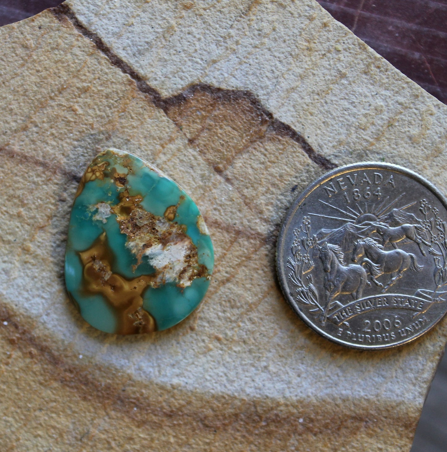 12 carat green Stone Mountain Turquoise cabochon with red inclusions