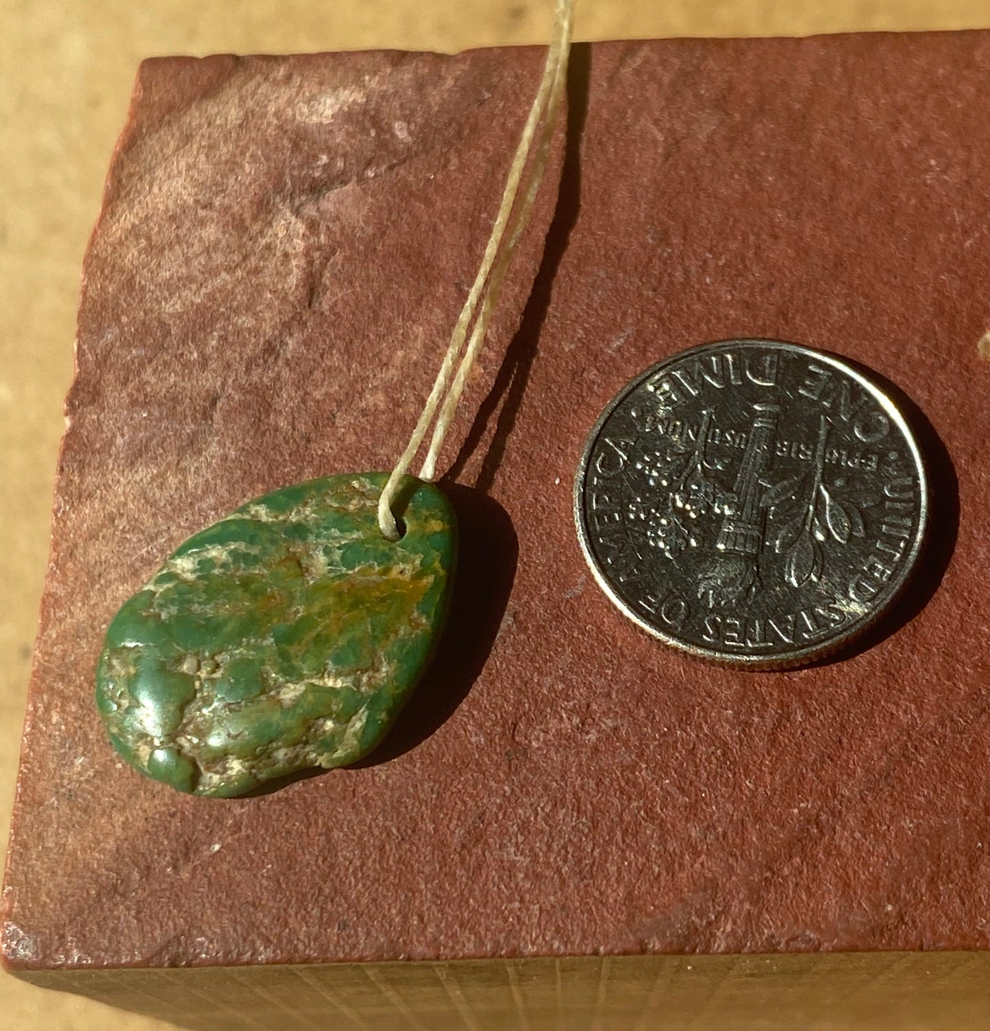 7 carat dark green Stone Mountain Turquoise tab style bead with inclusions