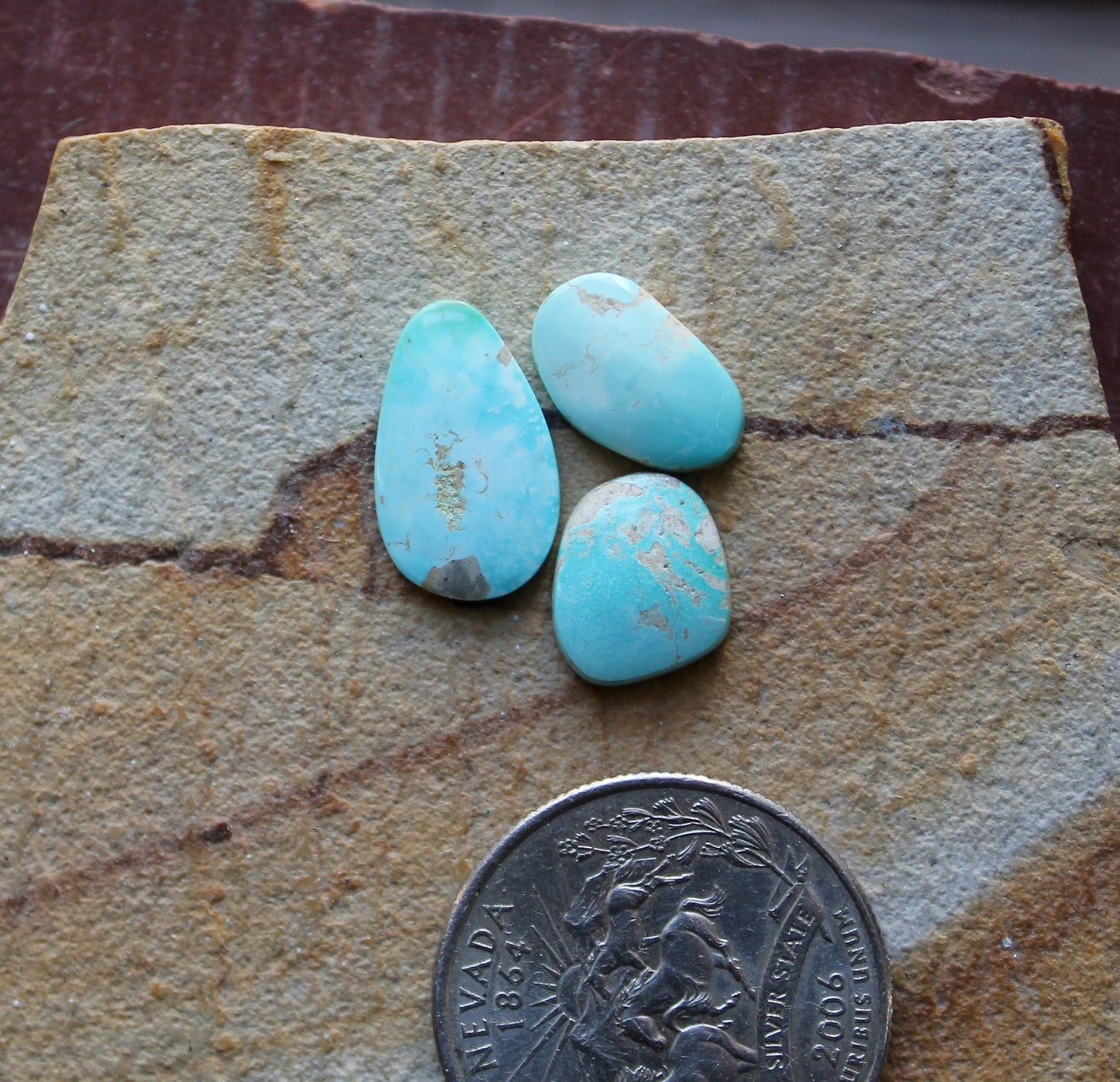 A trio of light blue Stone Mountain Turquoise cabochons
