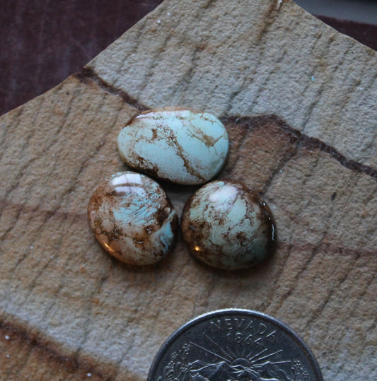 A trio of light blue Stone Mountain Turquoise cabochons with iron inclusions