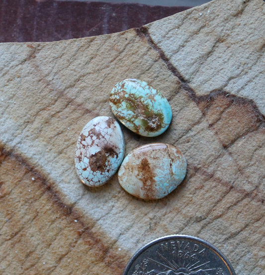 A trio of light blue Stone Mountain Turquoise cabochons infused with iron