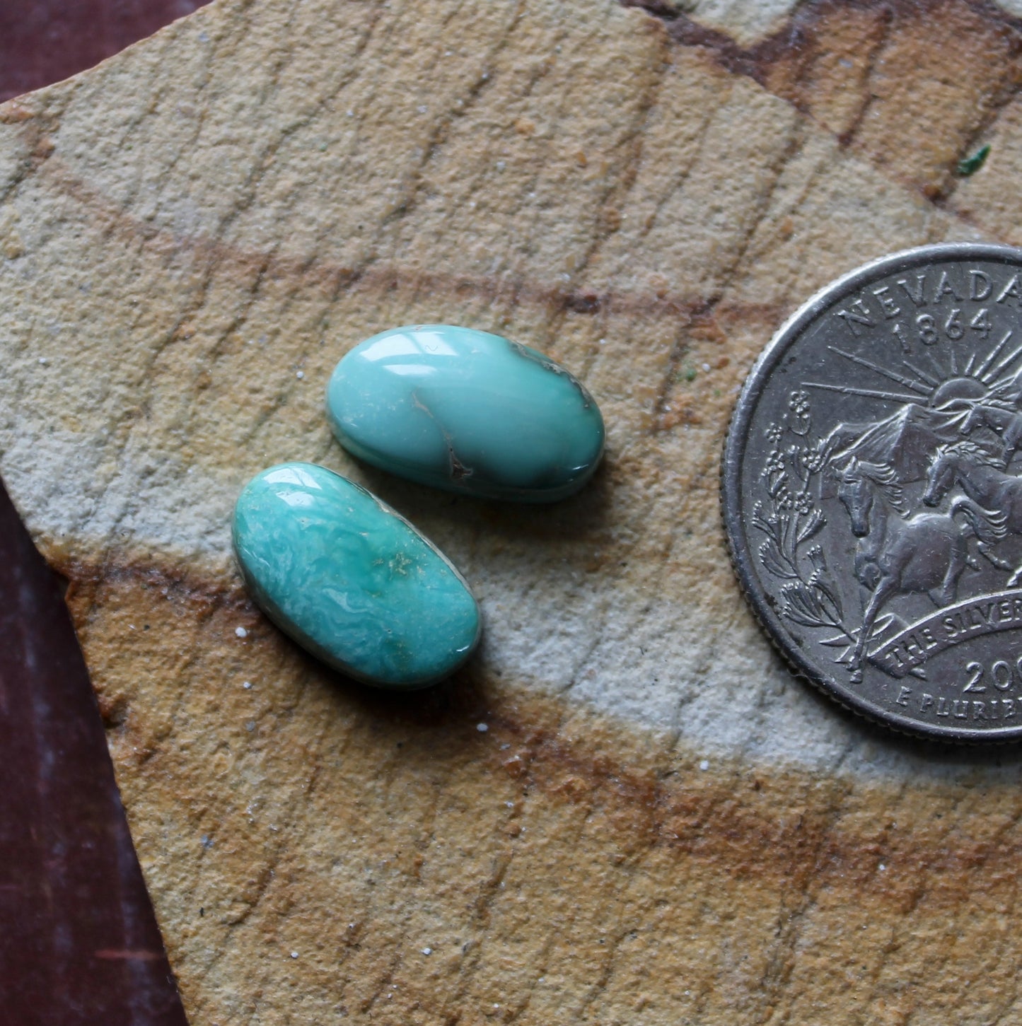 A pair of sea green Stone Mountain Turquoise cabochons