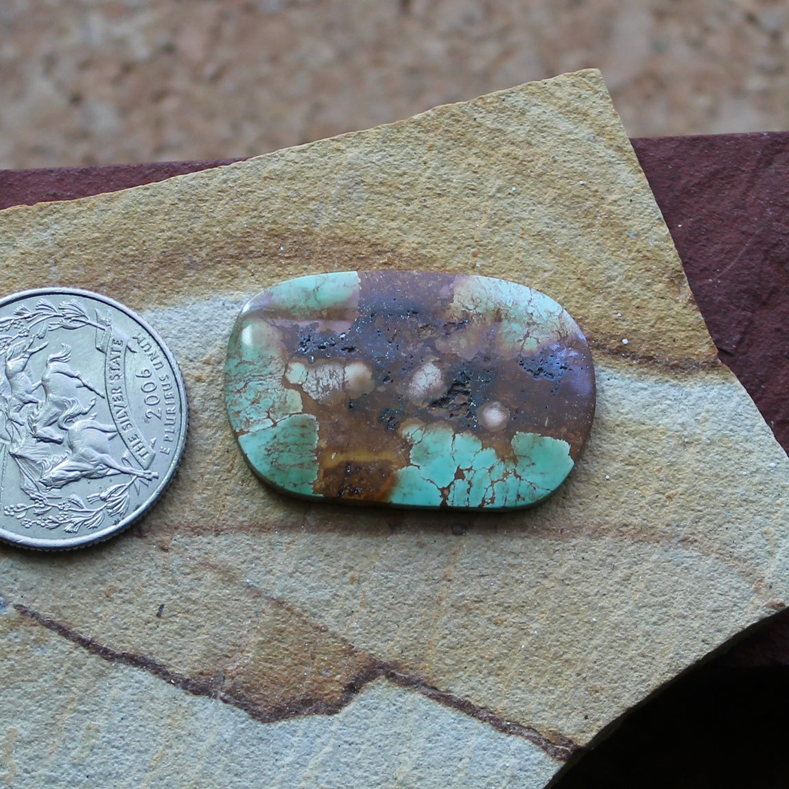 21 carat green Stone Mountain Turquoise flat-top cabochon with red inclusions
