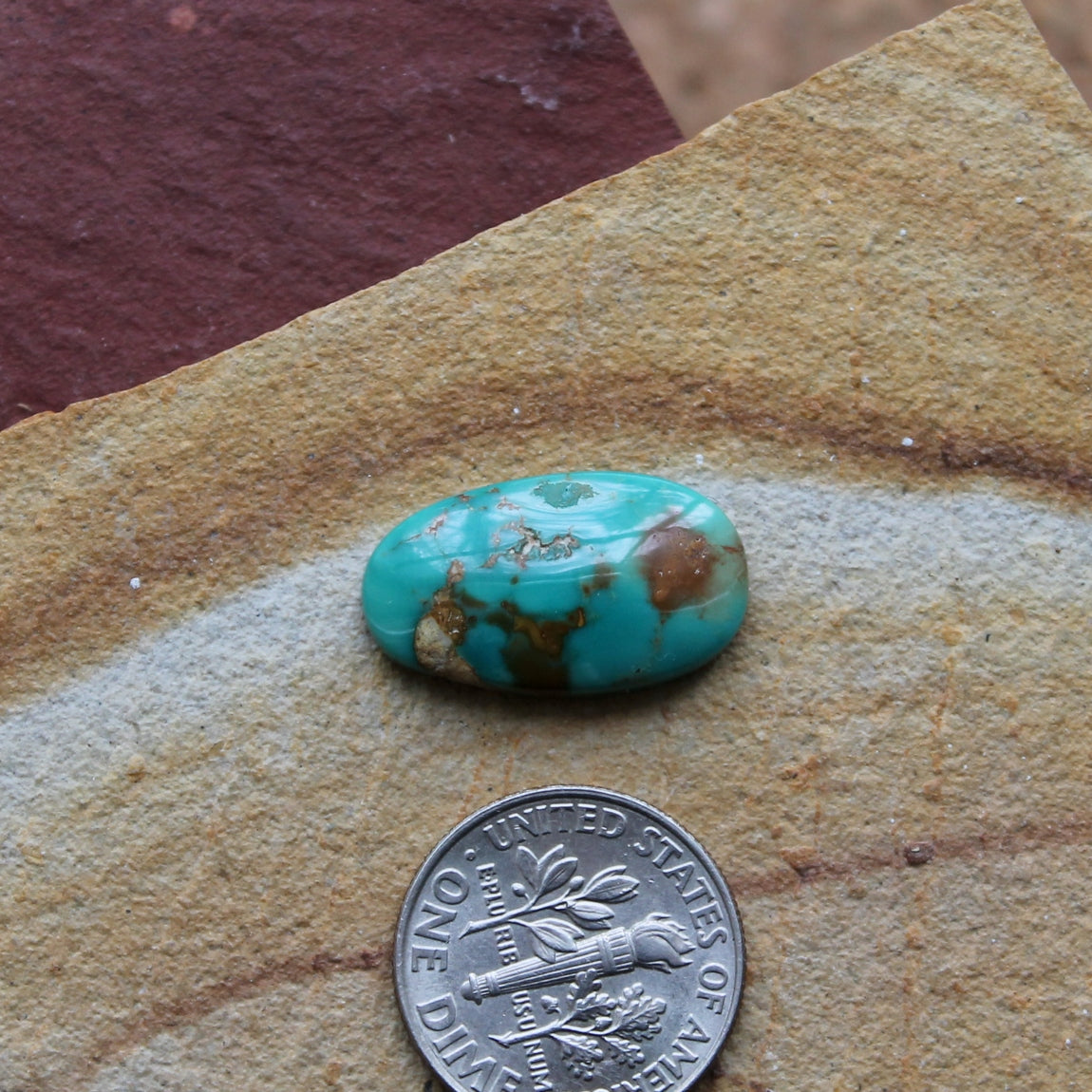 7 carat teal green Stone Mountain Turquoise cabochon with a red inclusions