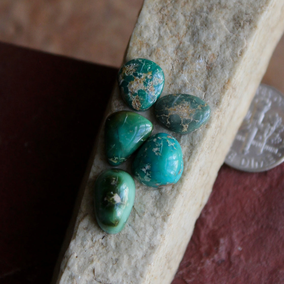 A mix of small green Stone Mountain Turquoise cabochons