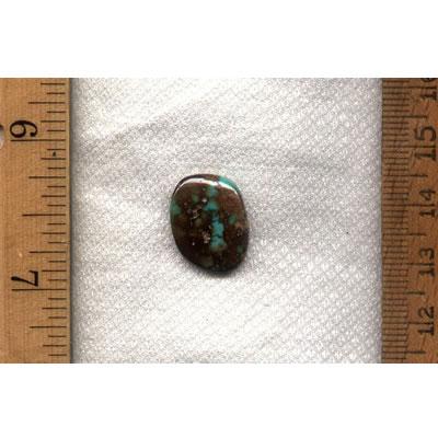 A blue Stone Mountain Turquoise cabochon with red iron spiderweb inclusions from the Nevada Cassidys 