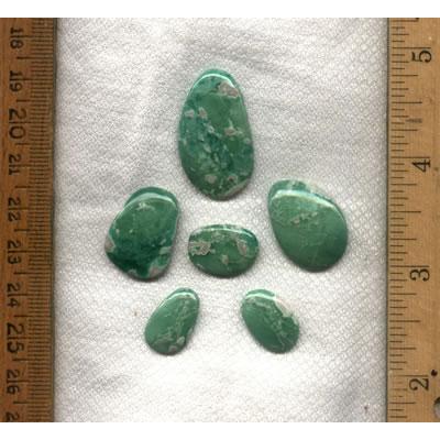 A six stone cabochon suite of apple green variscite from southern Utah.