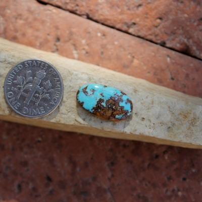 Bright blue contrasts by red matrix on this natural Nevada turquoise cabochon
