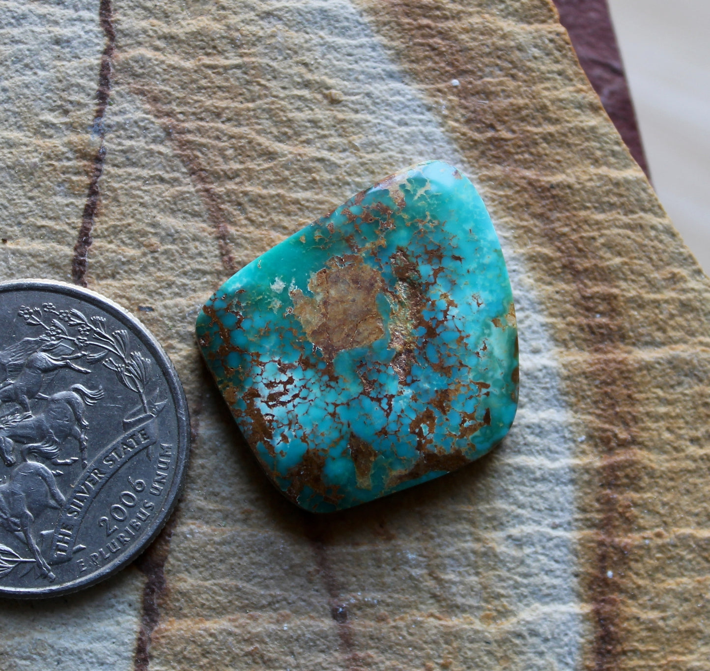 22 carat blue Stone Mountain Turquoise cabochon with red spiderweb matrix
