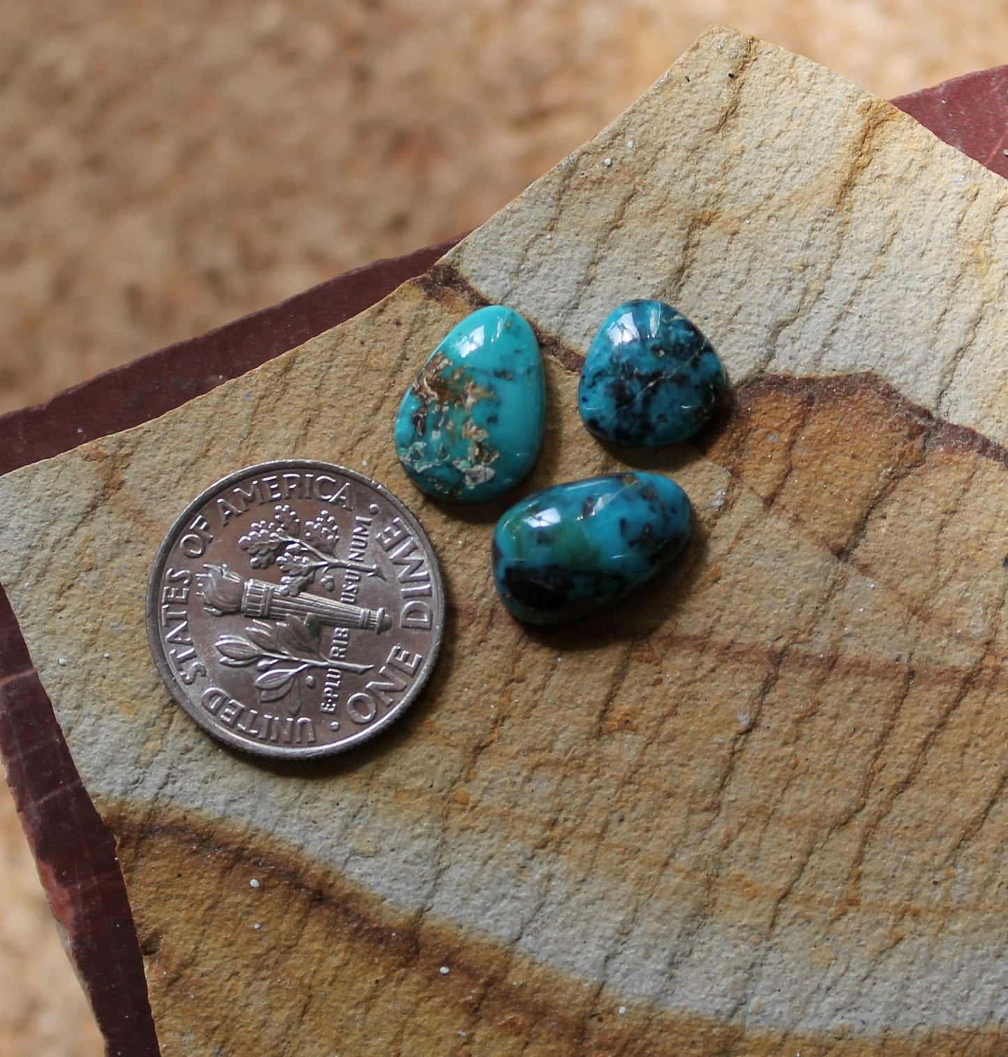 A trio of natural blue McGinnis turquoise cabochons