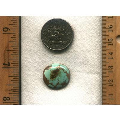 A round light blue turquoise cabochon with very interesting red inclusions . All natural turquoise from northern Nevada.